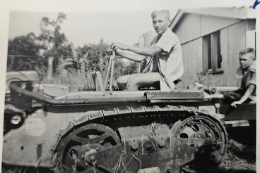 Charles on the tractor pulling the trough
