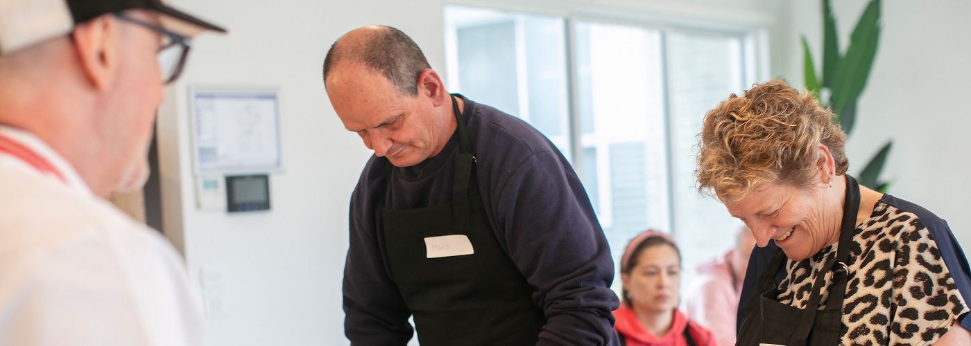 Two people in the kitchen cooking 