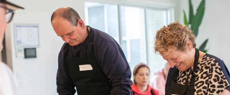 Two people in the kitchen cooking Two people in the kitchen cooking