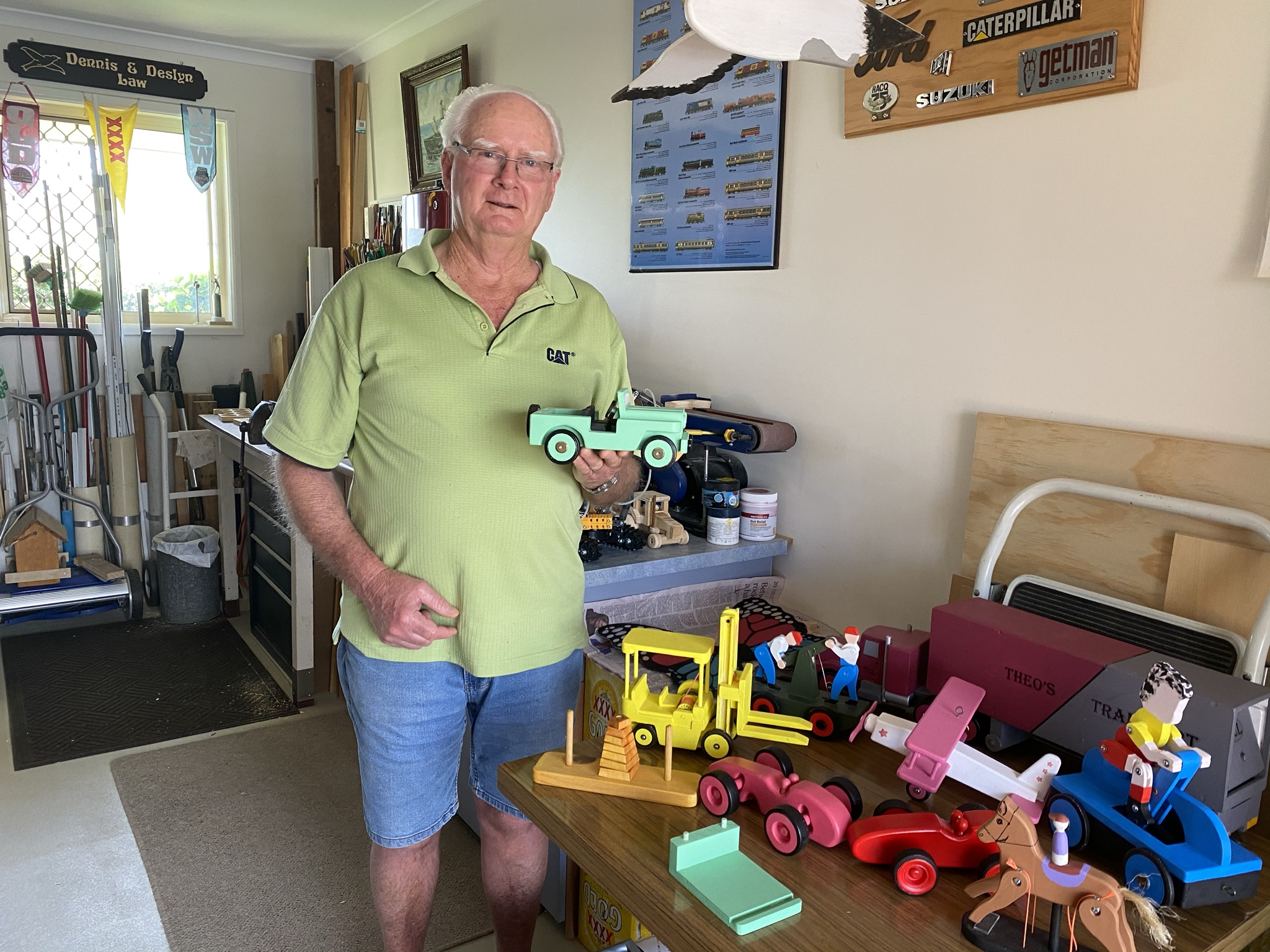 Dennis with toys in his workshop.JPEG