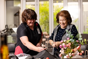 Two ladies looking through independent living equipment 