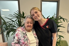 An elderly resident with young Bolton Clarke staff member, smiling An elderly resident with young Bolton Clarke staff member, smiling