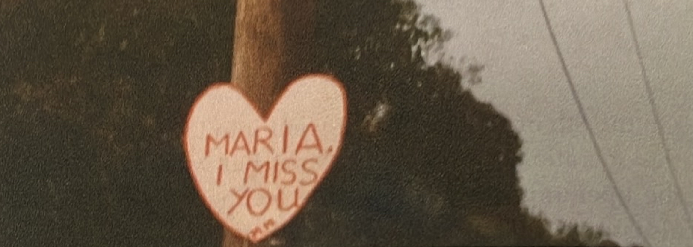 Michael's sign for Maria reading 'Maria, I miss you'