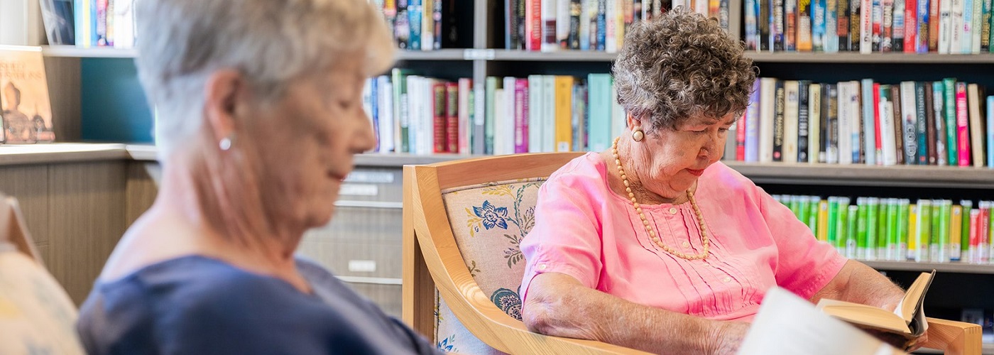 Two elderly females reading peacefully 