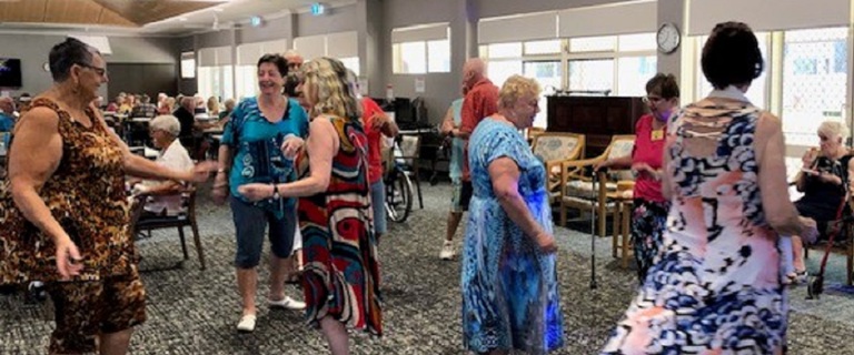 A group of retirement village residents dancing A group of retirement village residents dancing