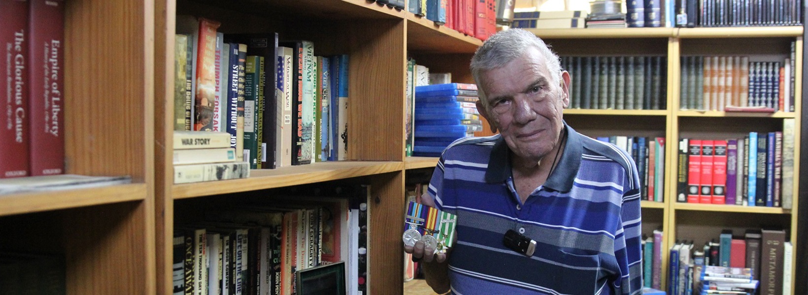 Gus in his home library.jpg Gus in his home library.jpg