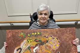 Jenny with one of her gifted paintings_.jpg Jenny with one of her gifted paintings_.jpg