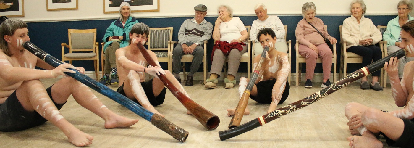 Students playing didgeridoo for residents.jpg