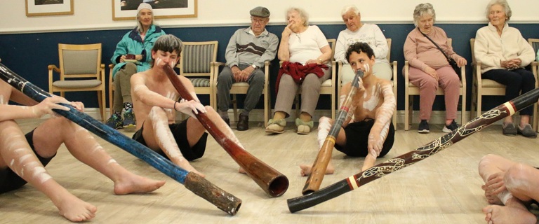 Students playing didgeridoo for residents.jpg Students playing didgeridoo for residents.jpg