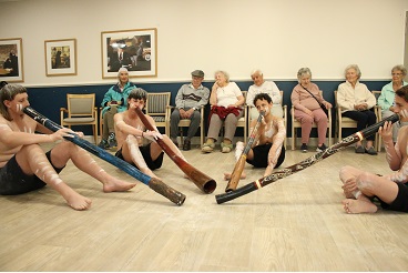 Students playing didgeridoo for residents_.jpg